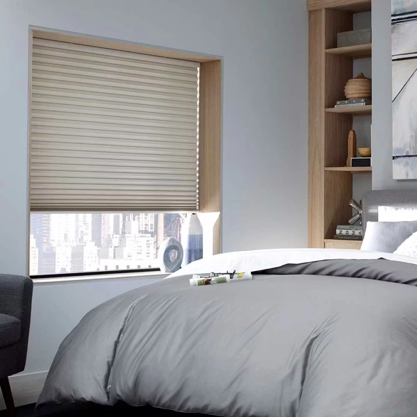 Beige pleated blinds in a modern bedroom.