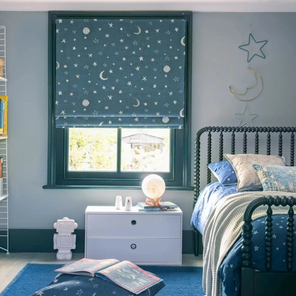 Blue celestial pattern Roman shades in a nursery.