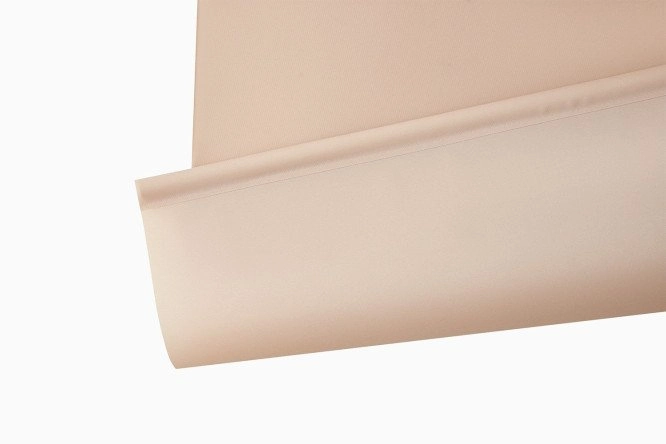 Close-up of a light beige blackout blind fabric