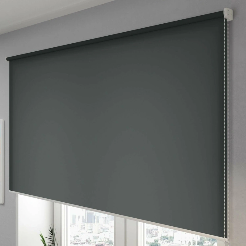 Dark gray blackout roller blind on window