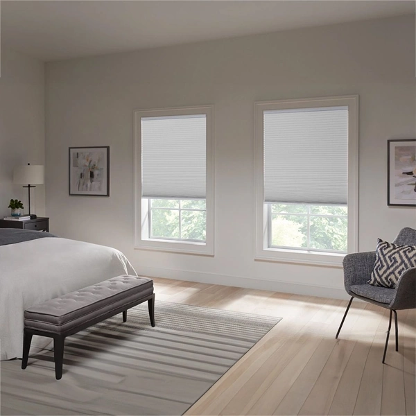 Two white cellular shades in a minimalist suite.