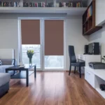 chocolate brown blackout blinds installed on balcony doors in a contemporary living room.