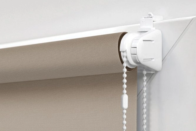 mounting bracket and beaded chain attached to a latte blackout roller blind.