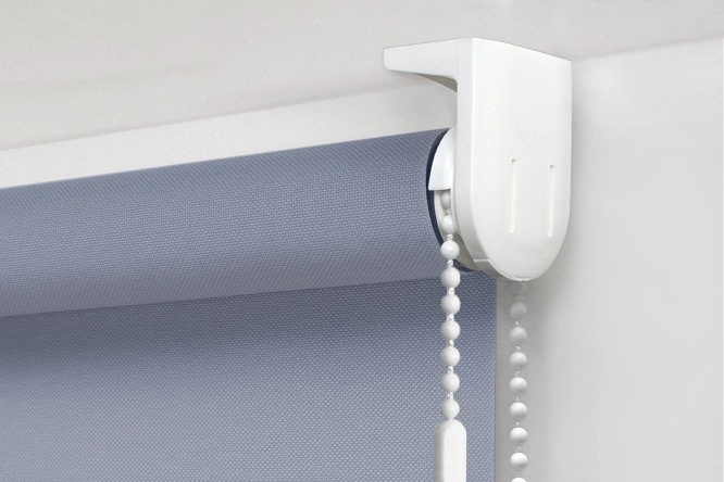 top-fix mounting bracket holding a denim blue roller blind